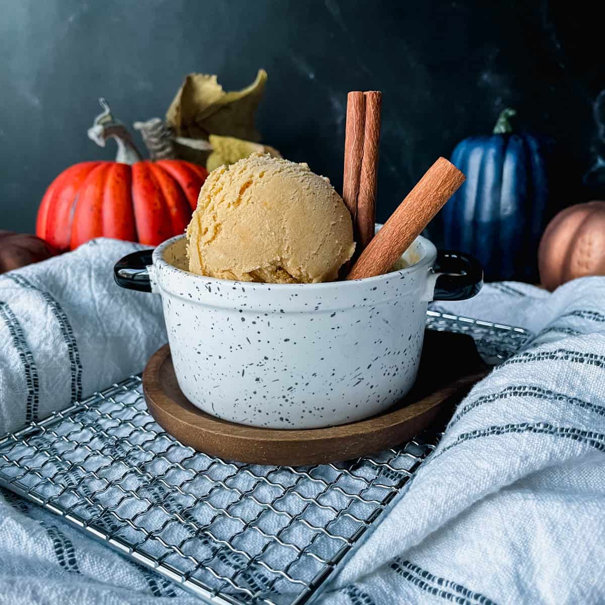 Pumpkin Bourbon Ice Cream in dish with cinnamon sticks.