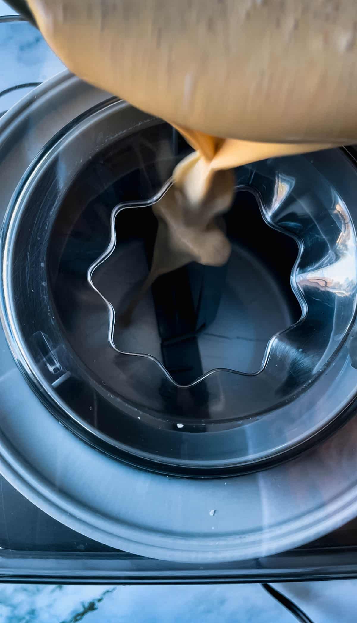 Pouring ice cream mixture into ice cream maker.