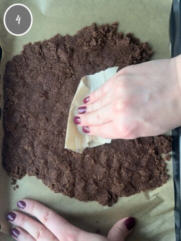 Patting baking chips into an even layer before baking.