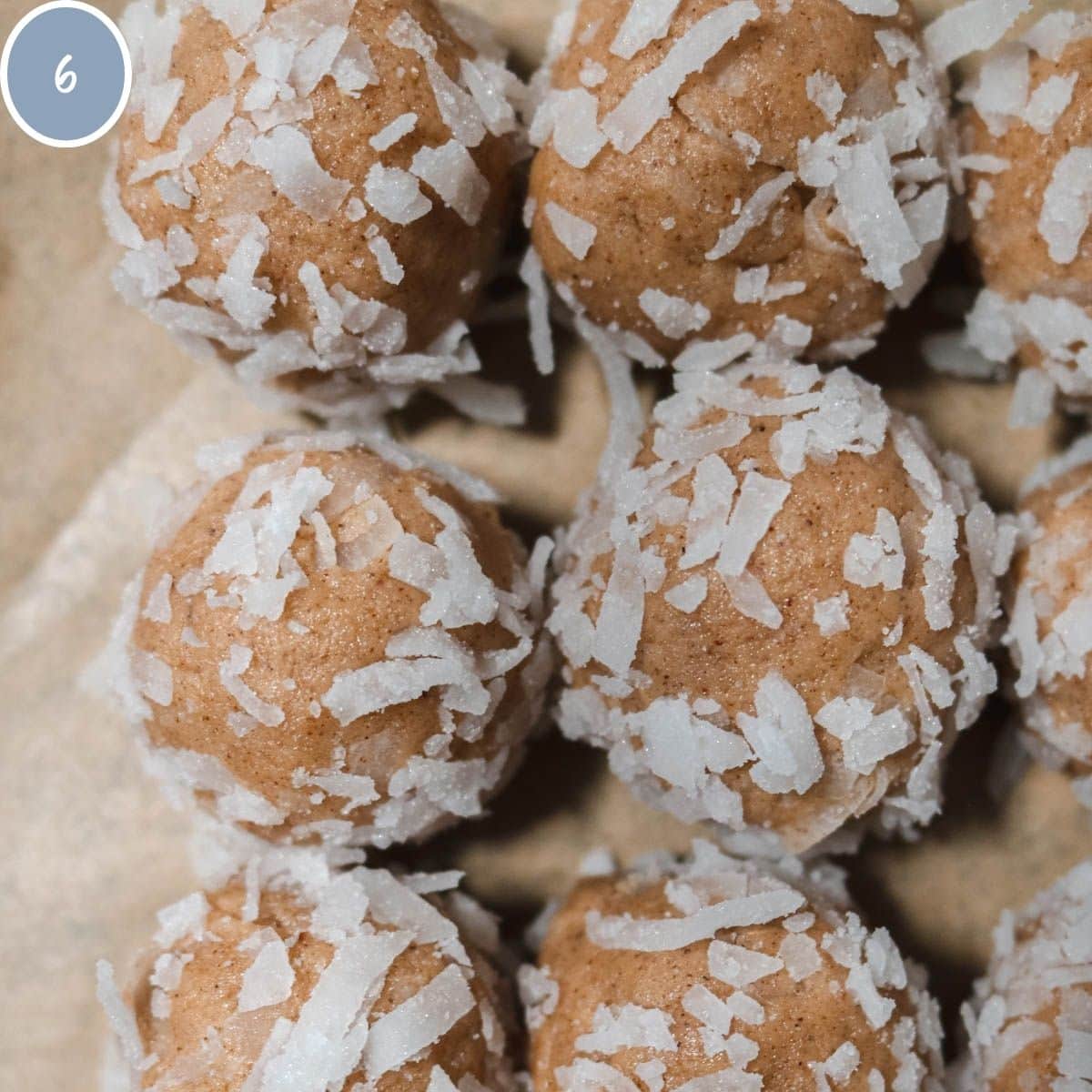 Balls of cookie dough rolled in shredded coconut.