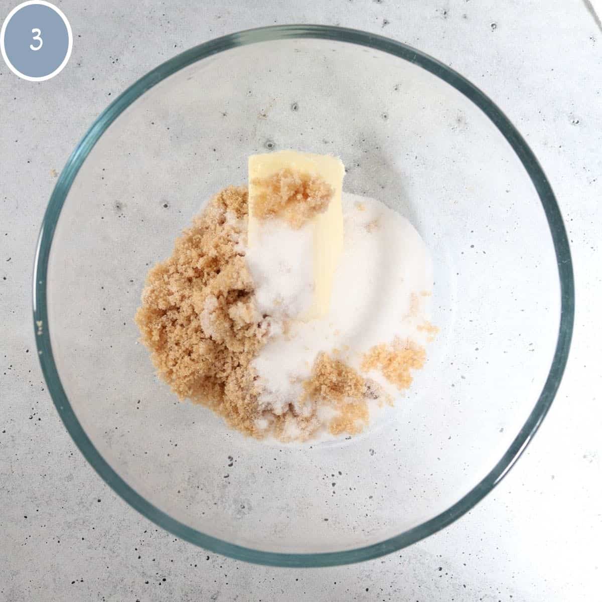 Butter and sugars in a bowl for eggnog cookies.