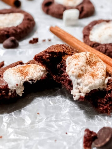 Mexican hot chocolate cookie broken in half with marshmallow oozing out.