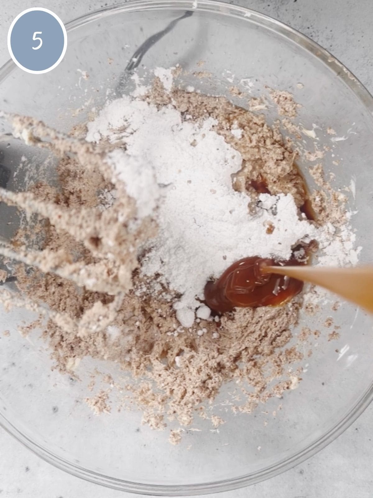 Adding powdered sugar, vanilla extract and caramel to mixture before mixing.
