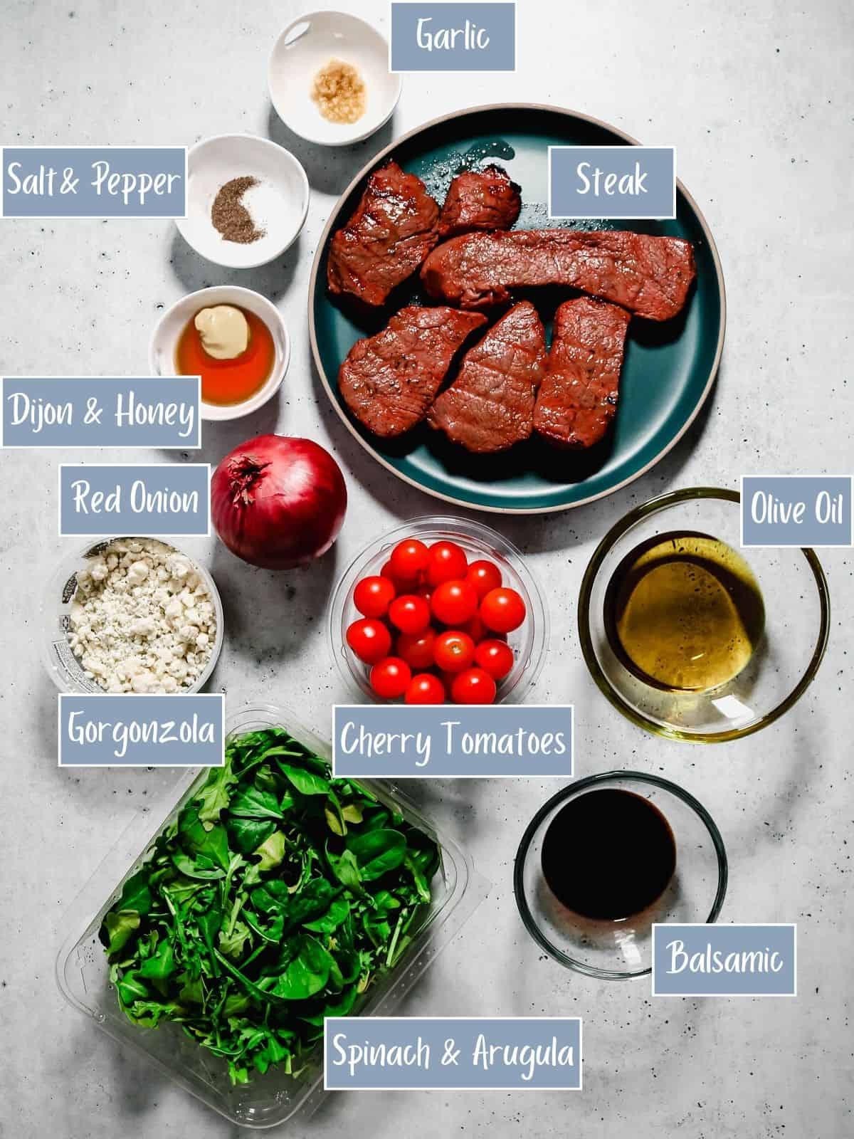 Labeled ingredients used to make an arugula spinach steak salad.