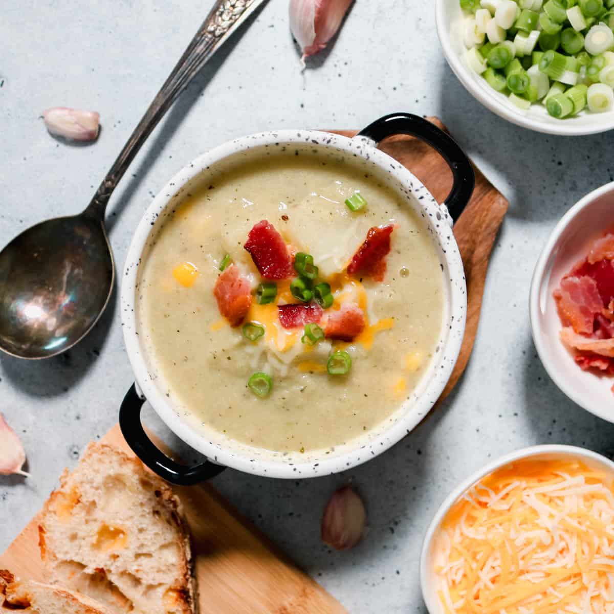 Overhead view of a bowl of cauliflower, leek and potato soup.