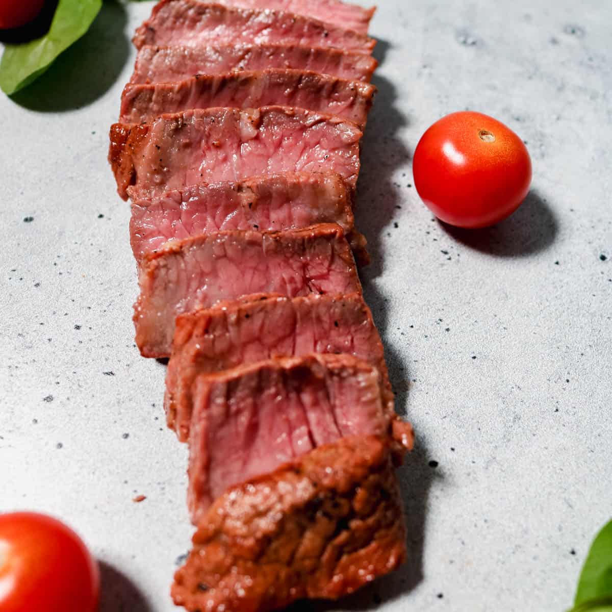 Sliced marinated medium-rare steak.