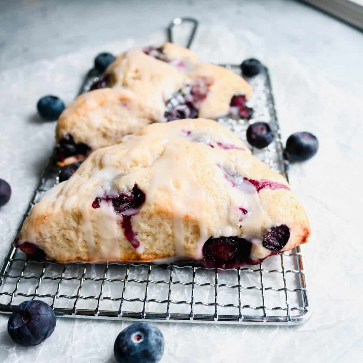 Side view of two sourdough lemon blueberry scones.