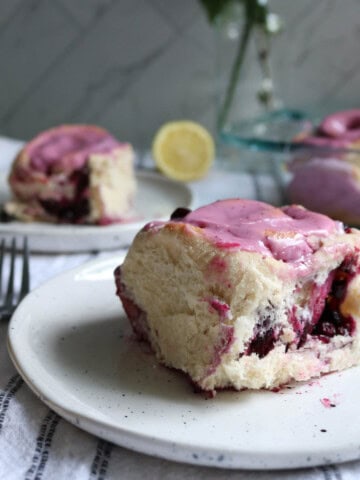 Side view of huckleberry sweet rolls with icing.