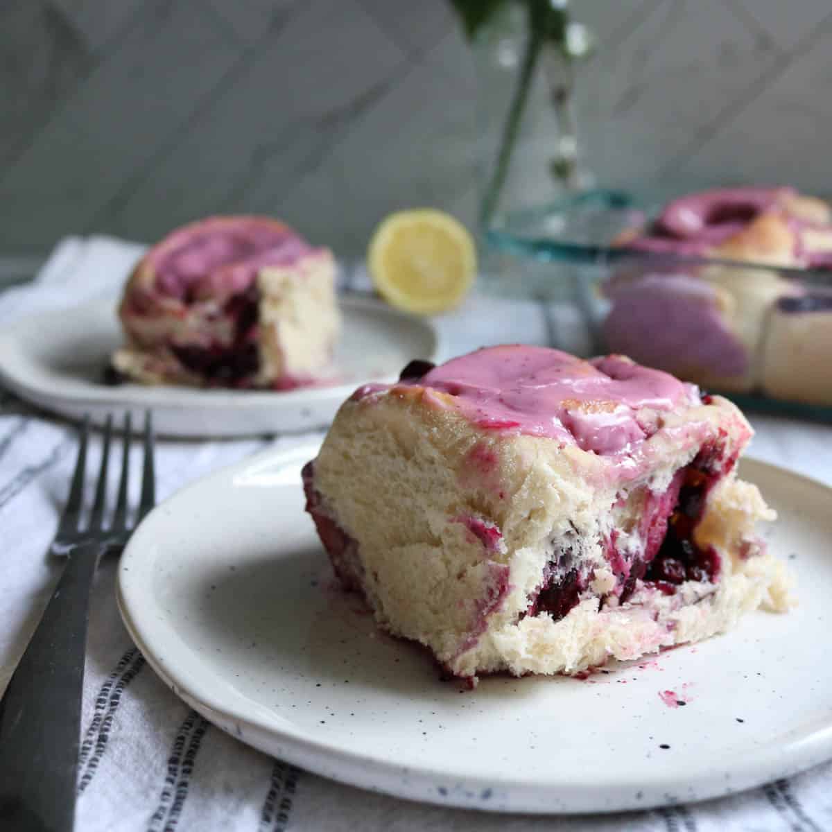 Side view of huckleberry sweet rolls with icing.