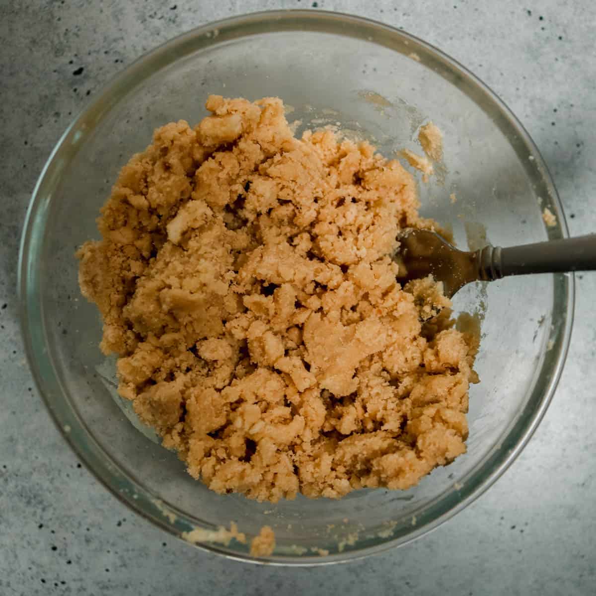 Ingredients for maple crumble mixed together in a bowl.