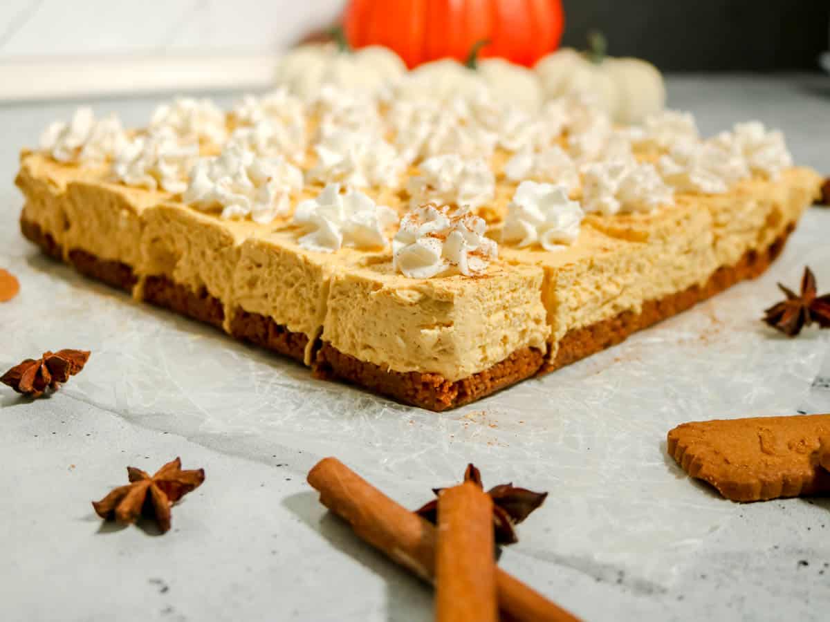 Finished no bake pumpkin cheesecake bars with Biscoff crust.