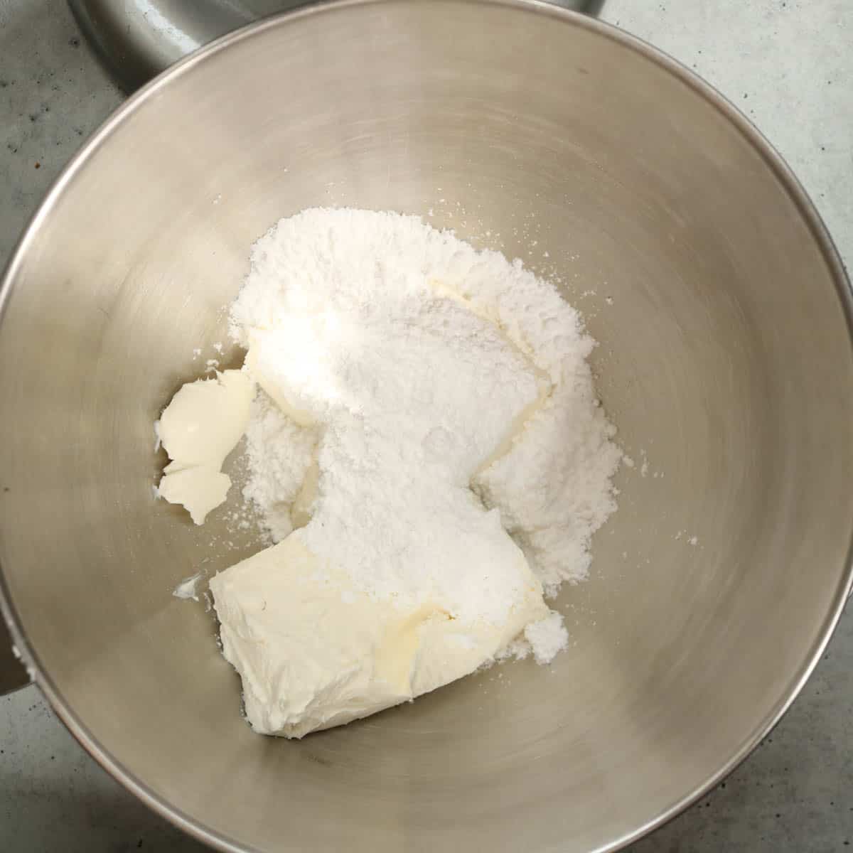 Cream cheese, salt and powdered sugar in the bowl of a stand mixer.