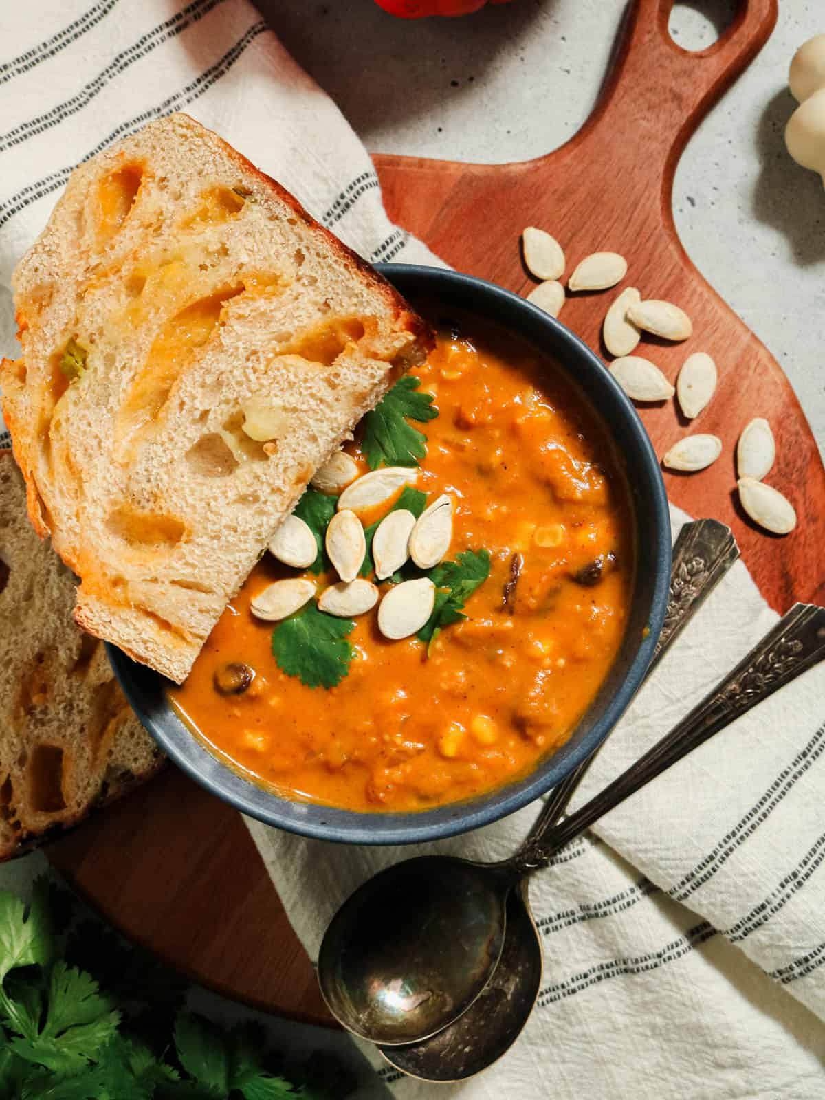 Overhead view of pumpkin chorizo soup with bread.