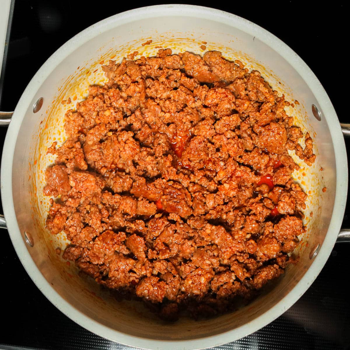 Chorizo browned in a stock pot.