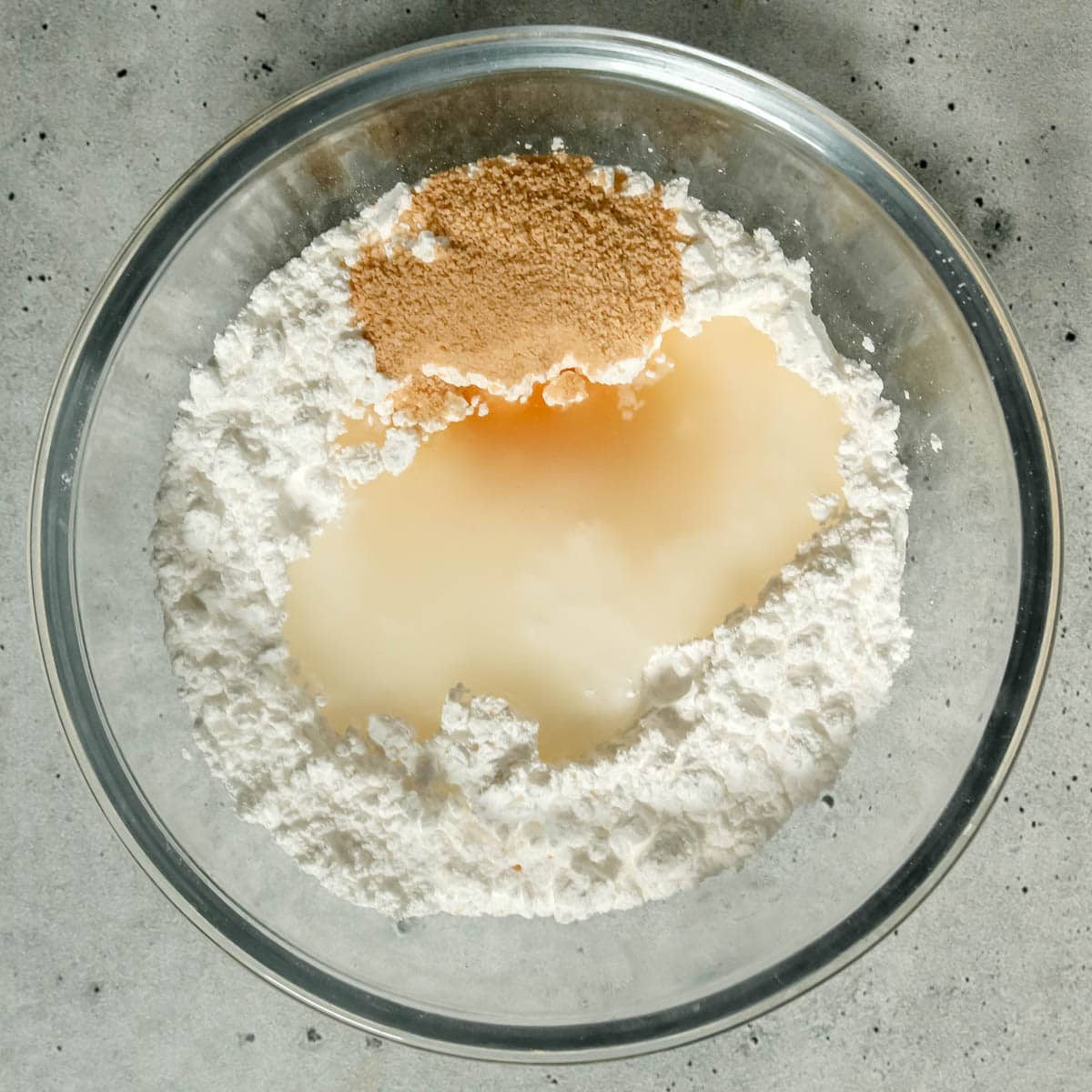 Ingredients to make apple cider icing in a bowl.