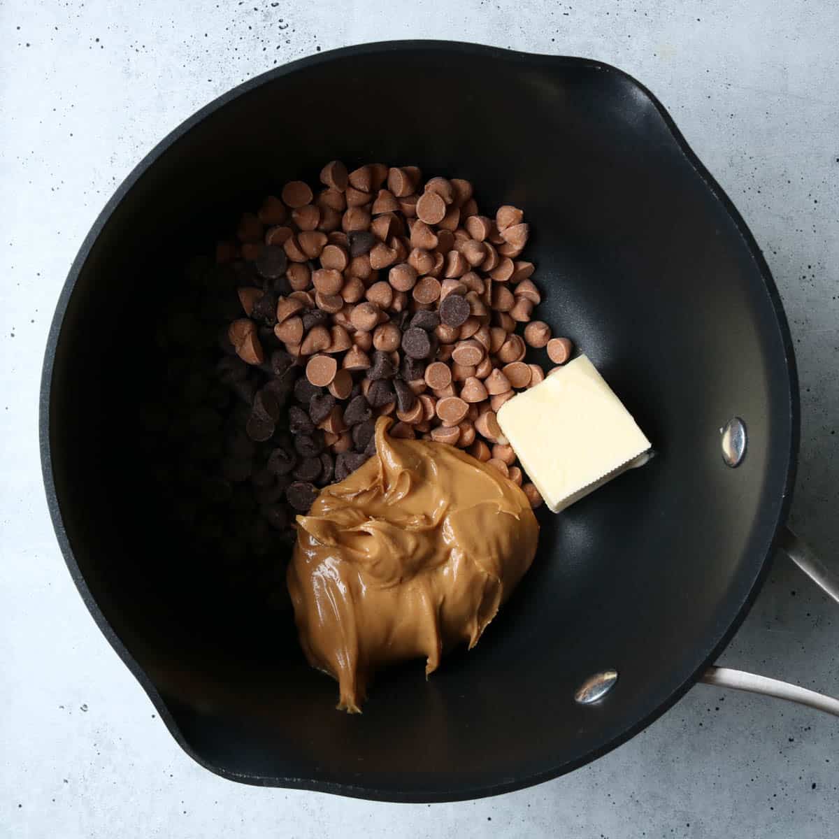 Initial ingredients to make fudge in a saucepan before cooking.