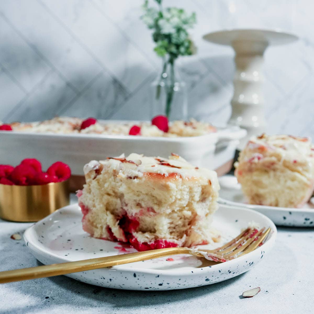 Sweet roll on a plate with the pan in the background.