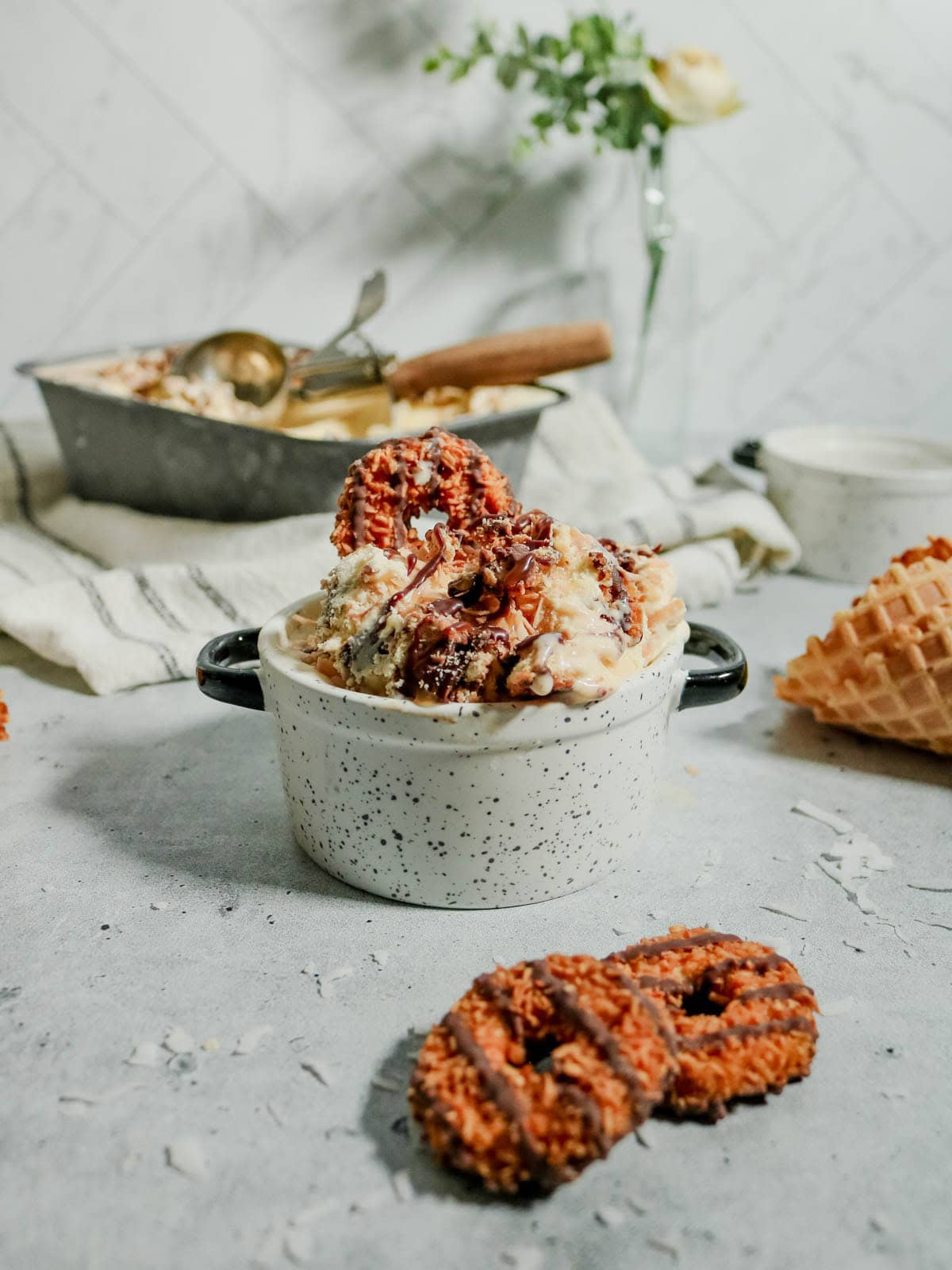 Samoa ice cream in a dish with a Samoa Cookie on top.