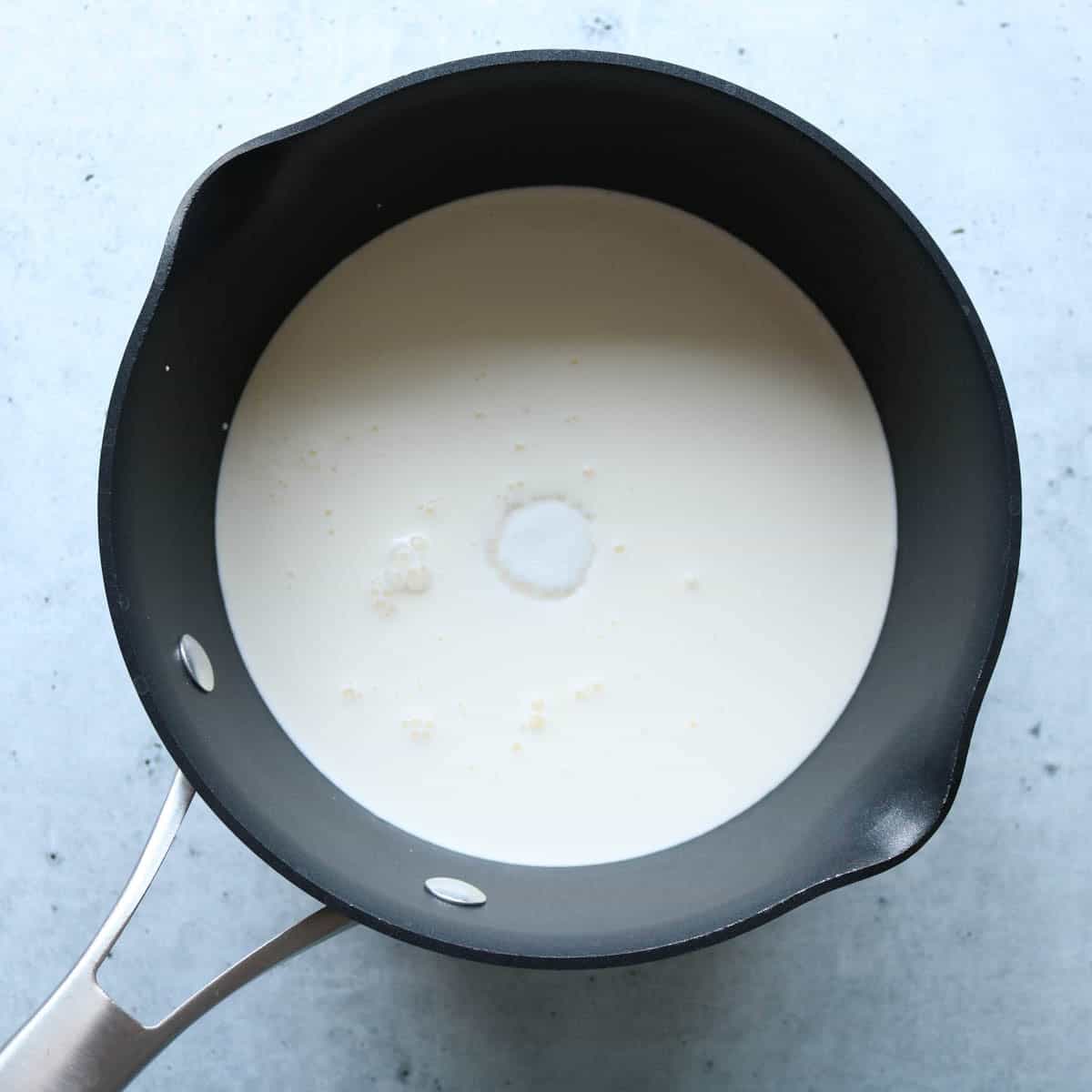 Sugar, milk and heavy cream in a saucepan.