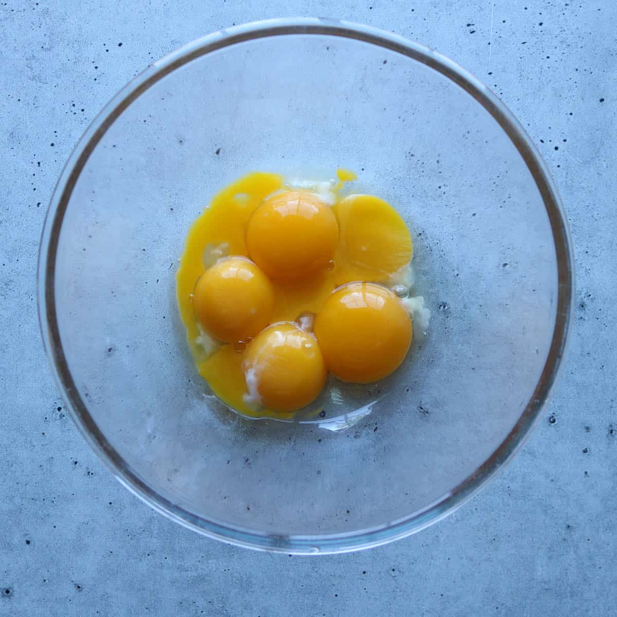 Egg yolks in a glass bowl.